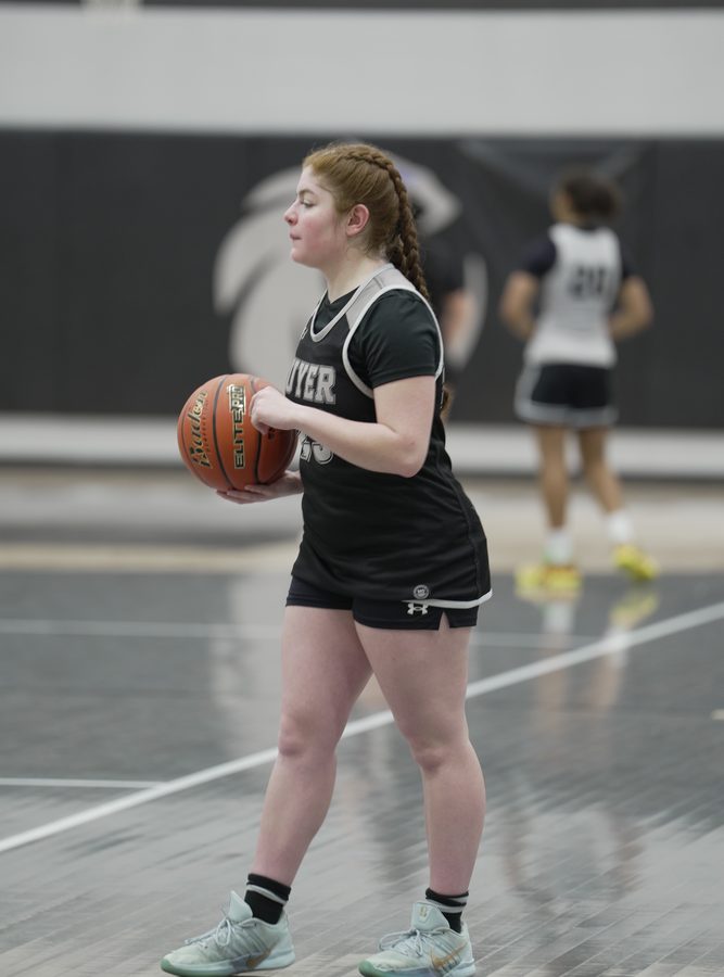 Illeana holds the ball with her eyes up the floor.